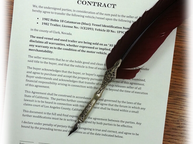 Feather pen laying on a document for business law concept