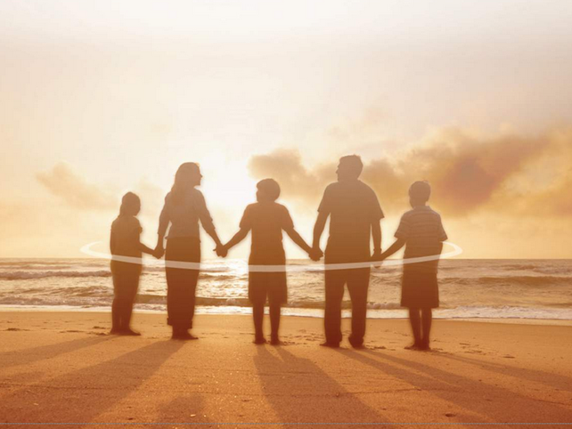 Family holding hands on the beach for Estate Planning