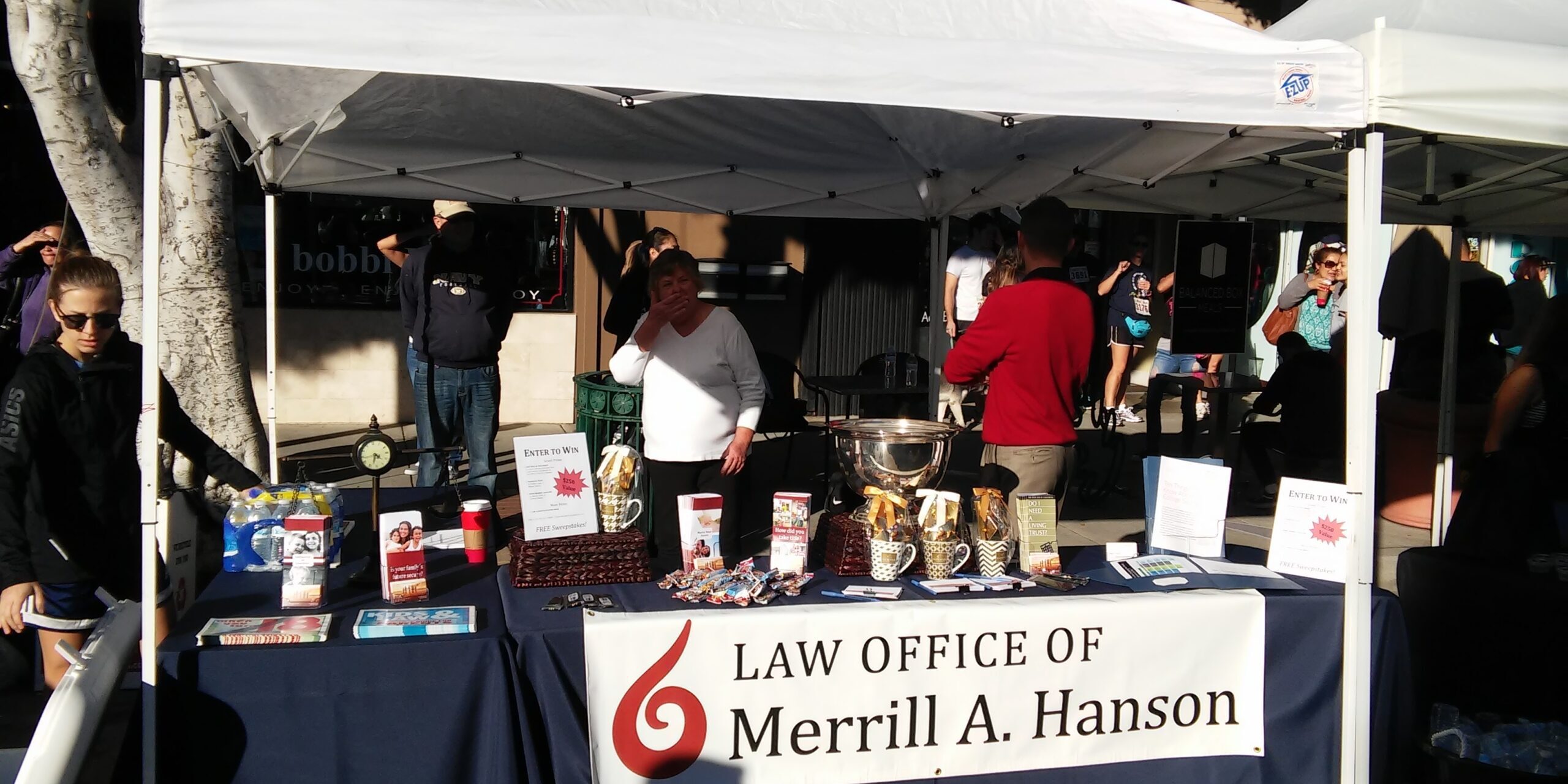 Booth set up with the banner Law Office of Merrill A. Hanson.