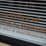 Word, Law Office of Merrill A. Hanson written on a window of his office.