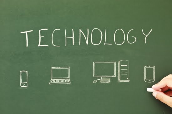 The words "technology" with and cell phone icon, computer icon, laptop icon, and tablet on a chalkboard.