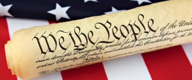 We the people scroll on the American Flag.