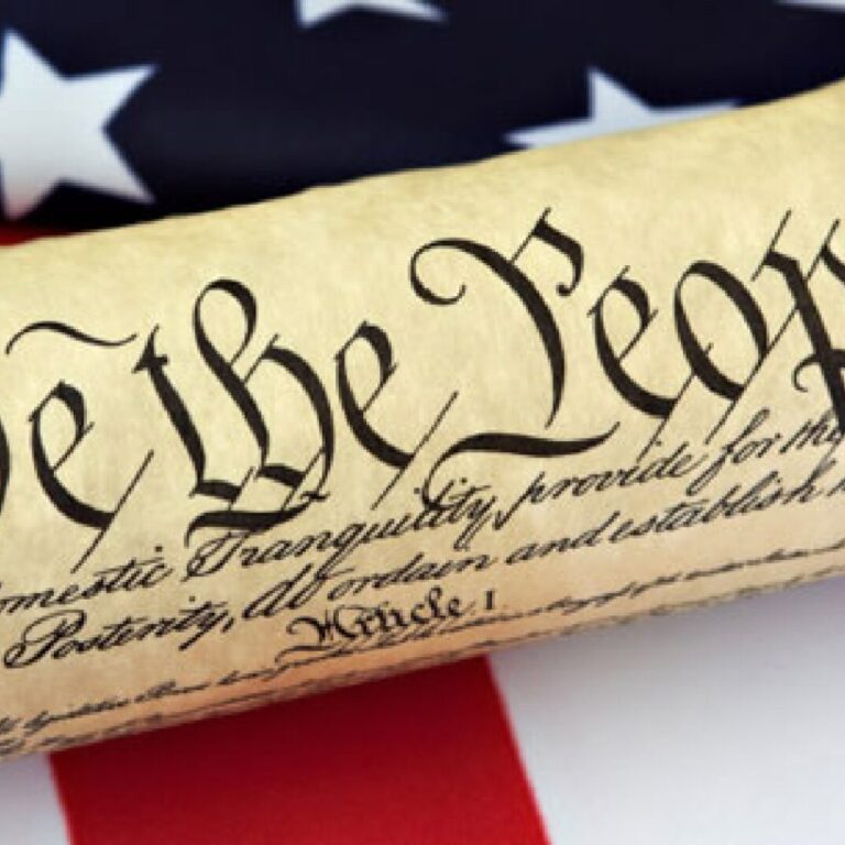 We the people scroll on the American Flag.