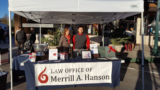 Merrill A. Hanson at a booth with a female staff.