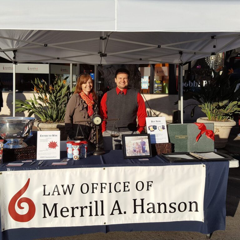 Merrill A. Hanson at a booth with a female staff.