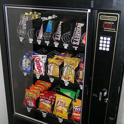 Vending machine filled with candy and chips.
