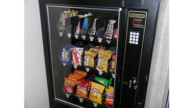 Vending machine filled with candy and chips.