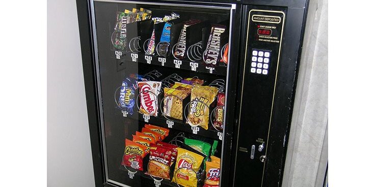 Vending machine filled with candy and chips.