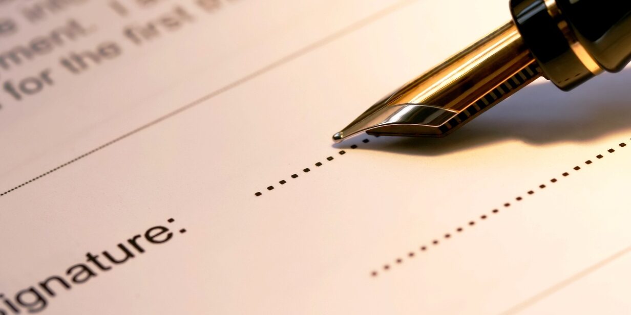 Signature line with a fountain pen ready to sign.