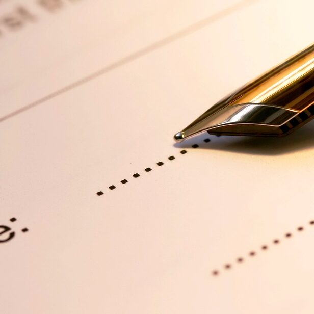 Signature line with a fountain pen ready to sign.