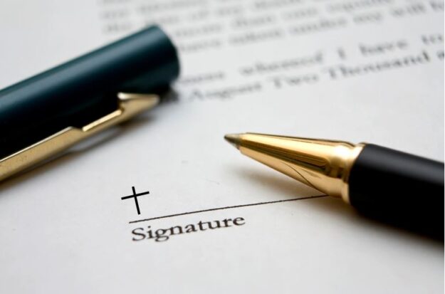Signature line with a cross and a pen.