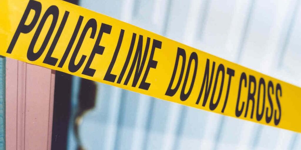 Yellow police tape with do not cross.