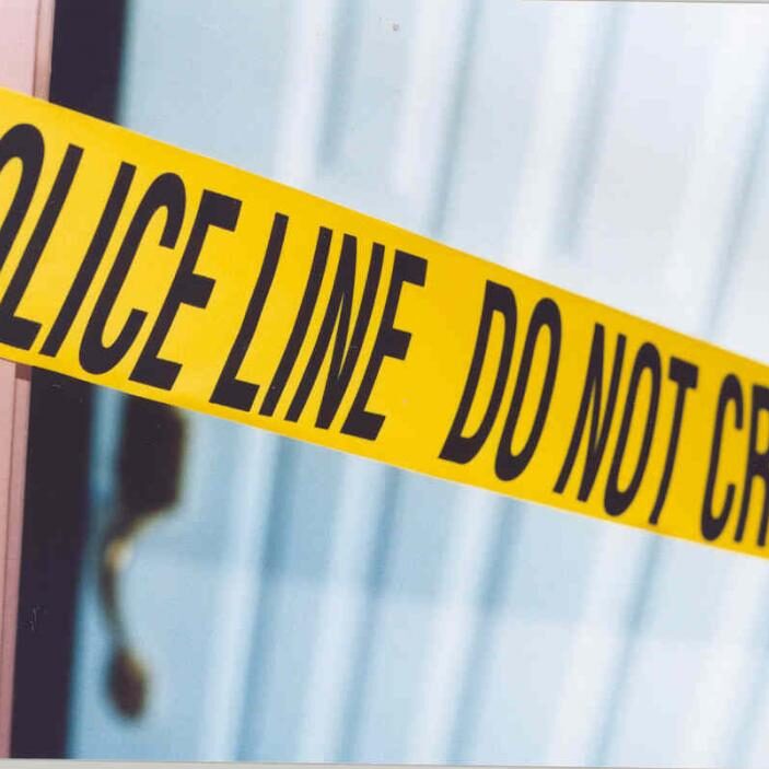 Yellow police tape with do not cross.