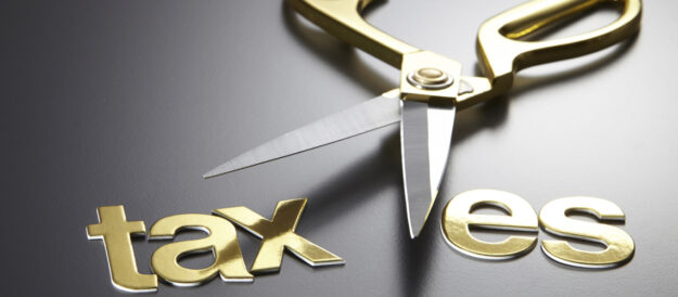 Gold succors with the concept of cutting through the word "taxes".
