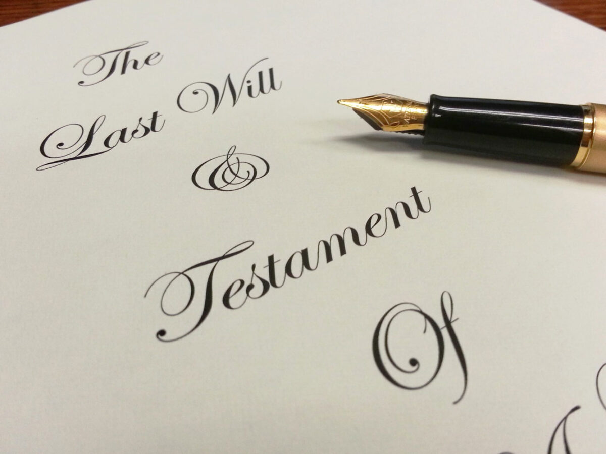 Paper with the last will and testament written on it.