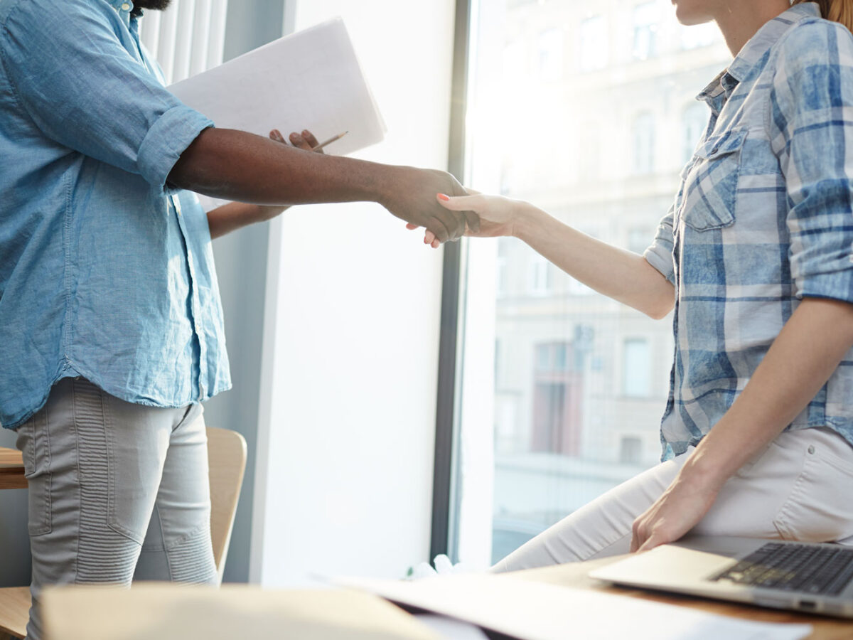 Man and woman shakes hands in a business agreement for Business Law